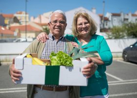 a couple holding fresh produce