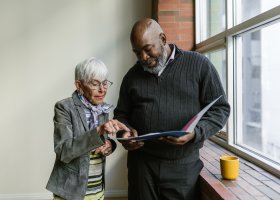 happy couple looking at documents